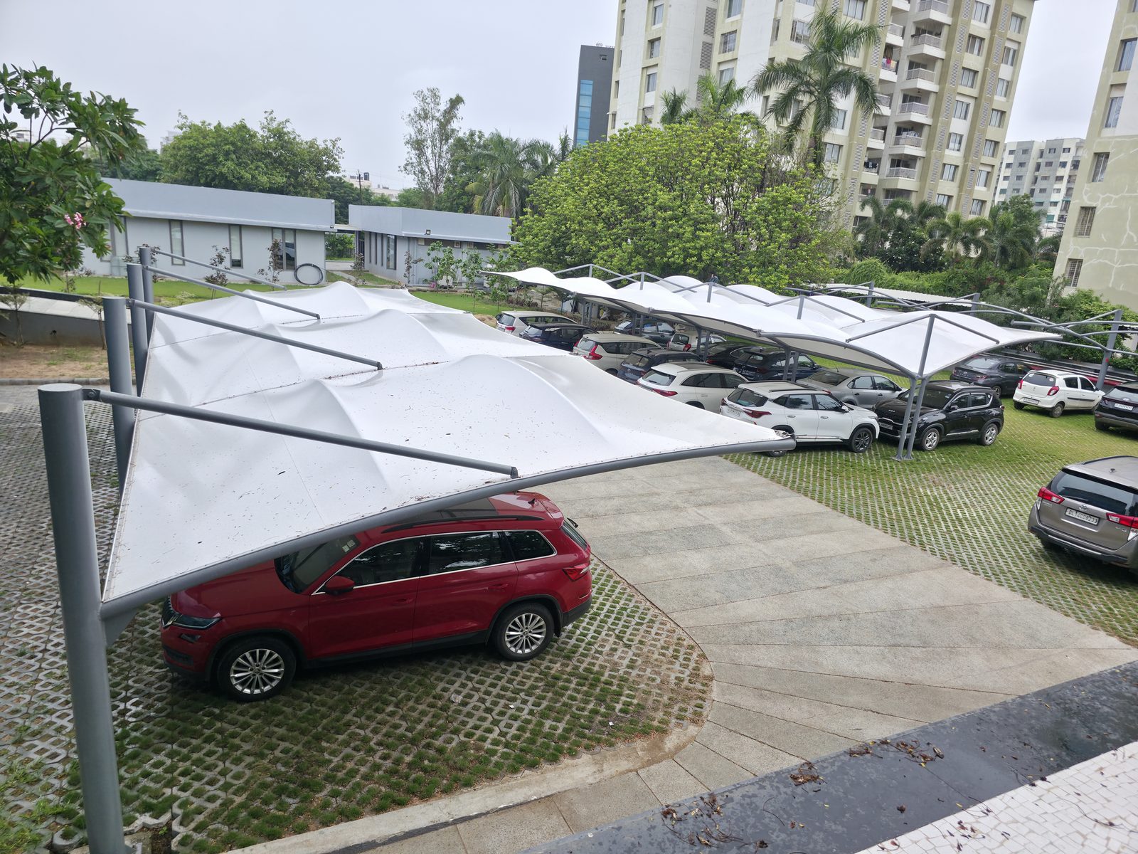 Wide view of a multi-bay cantilever parking canopy installation