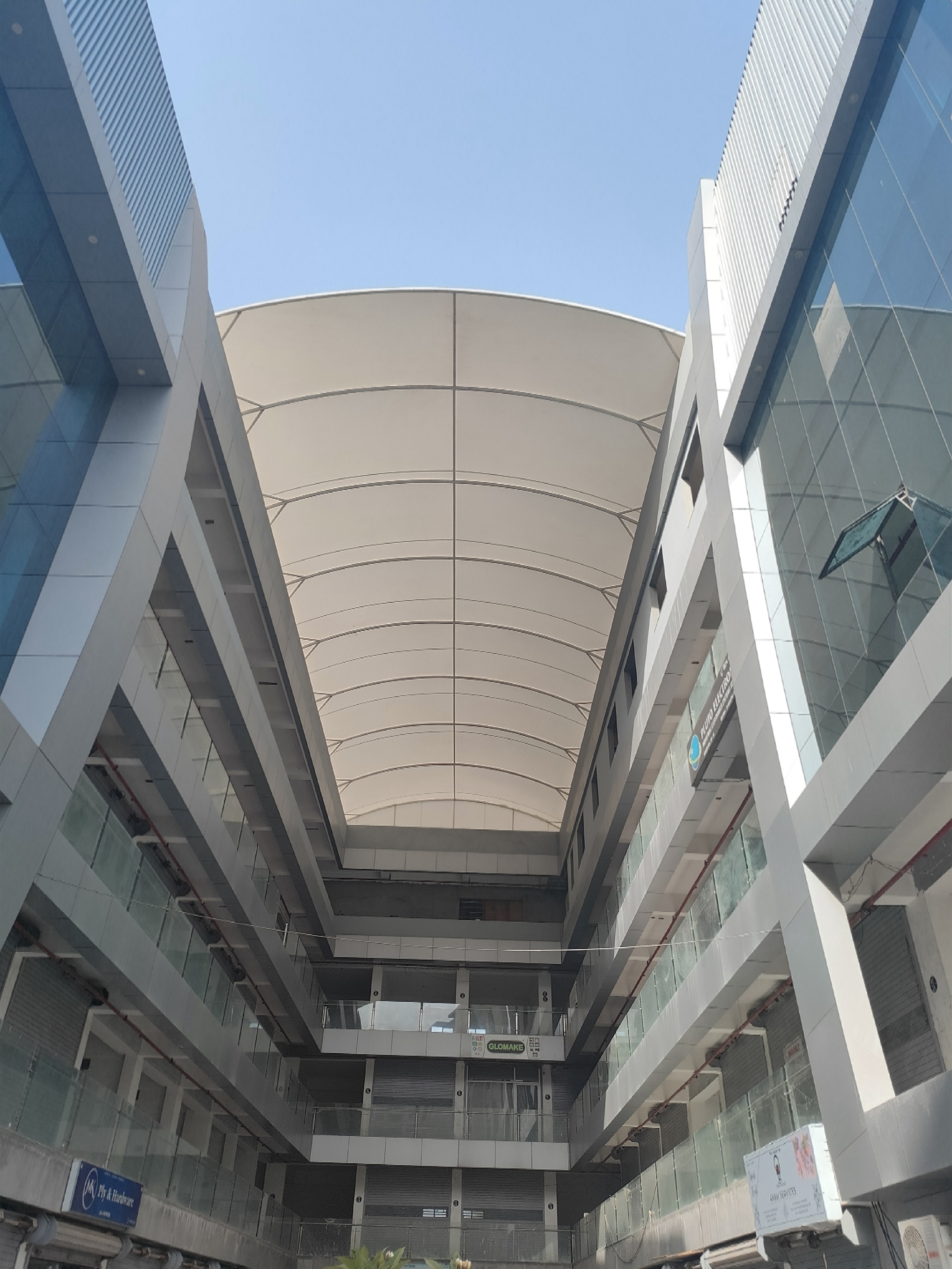 Barrel-vault tensile roof over a shopping arcade walkway