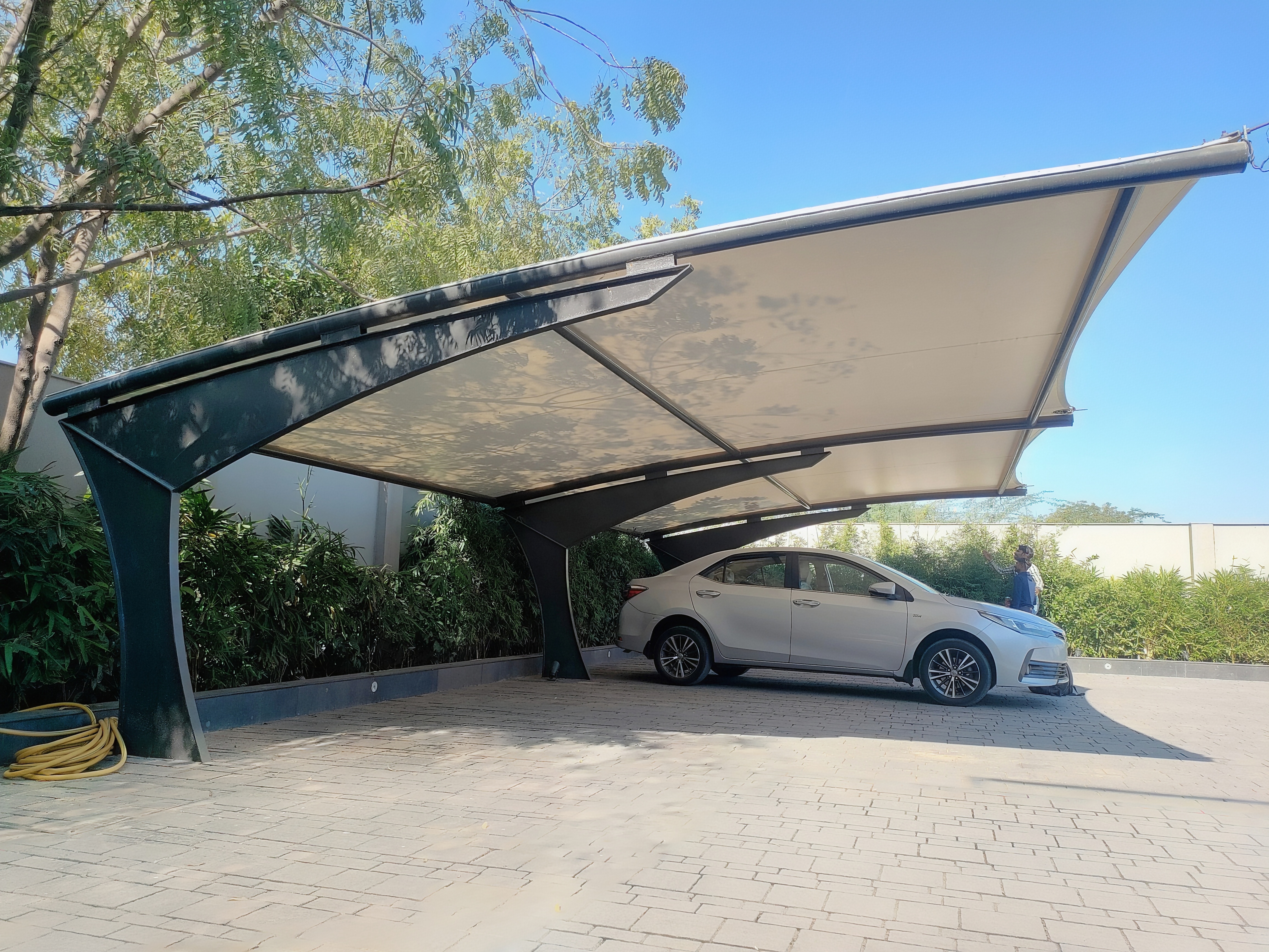 Modern angular cantilever carport canopy over a parked car