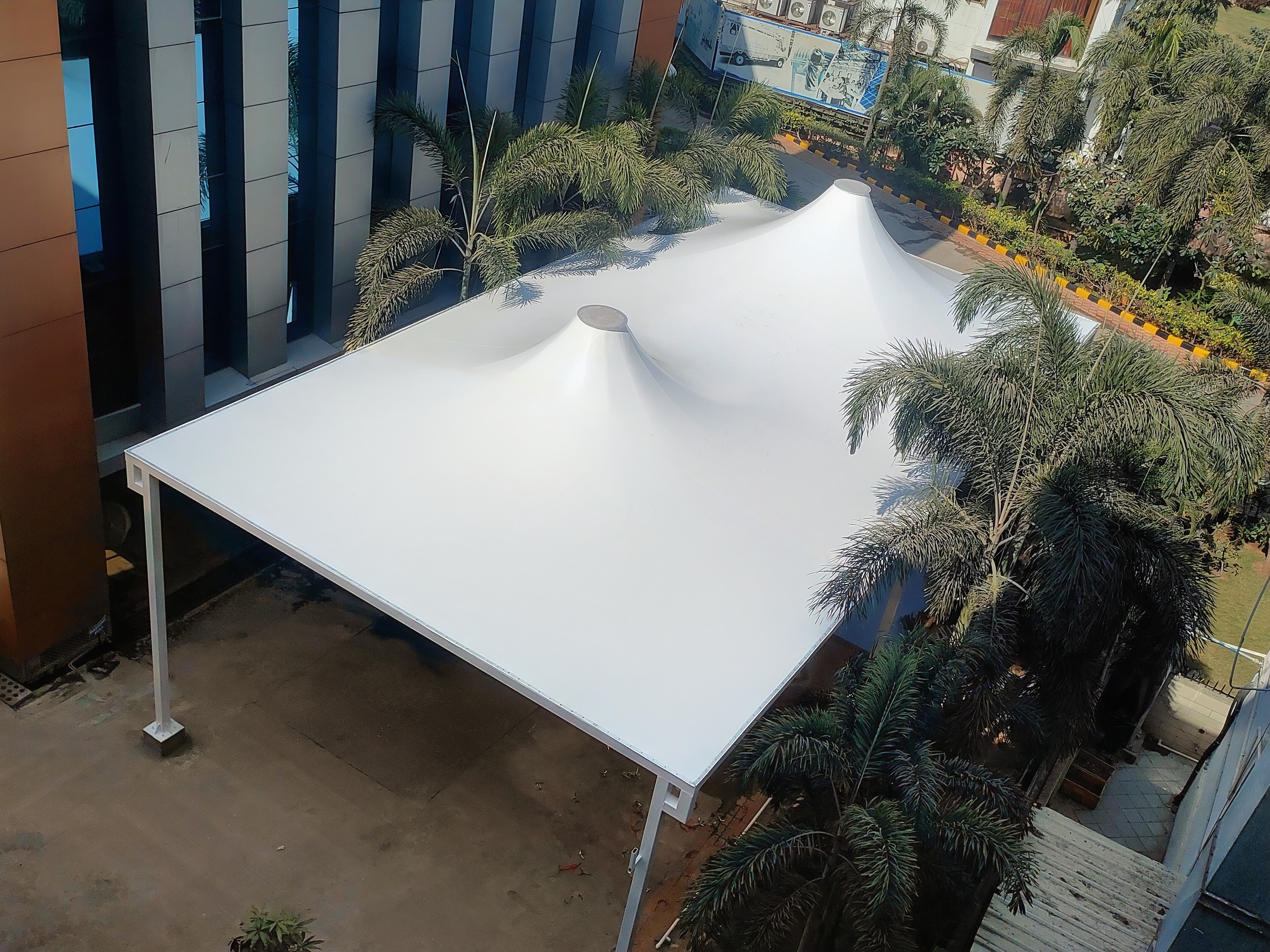 Aerial view of a double-peak tensile dome roof over a corporate building