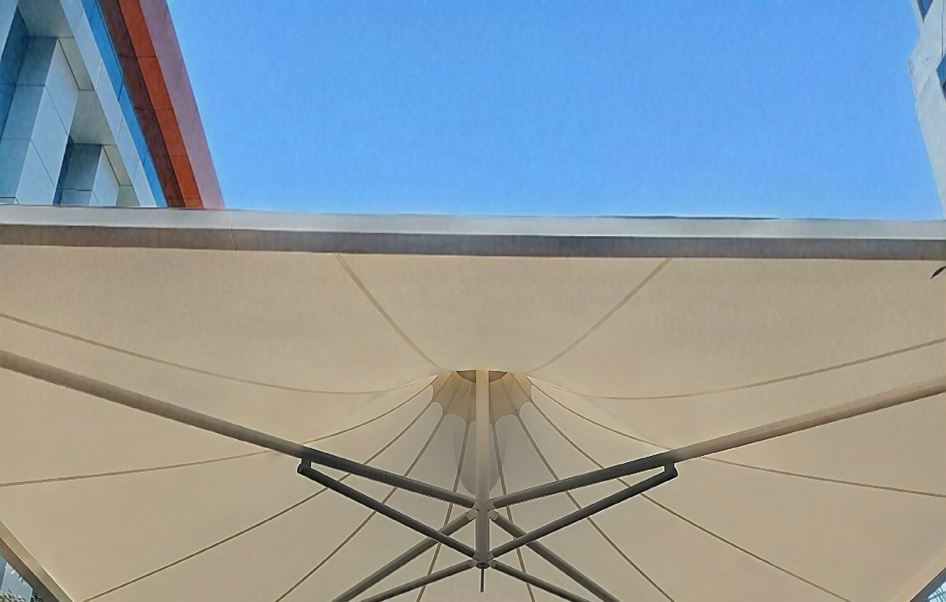 Pinwheel-shaped tensile canopy at a building entrance