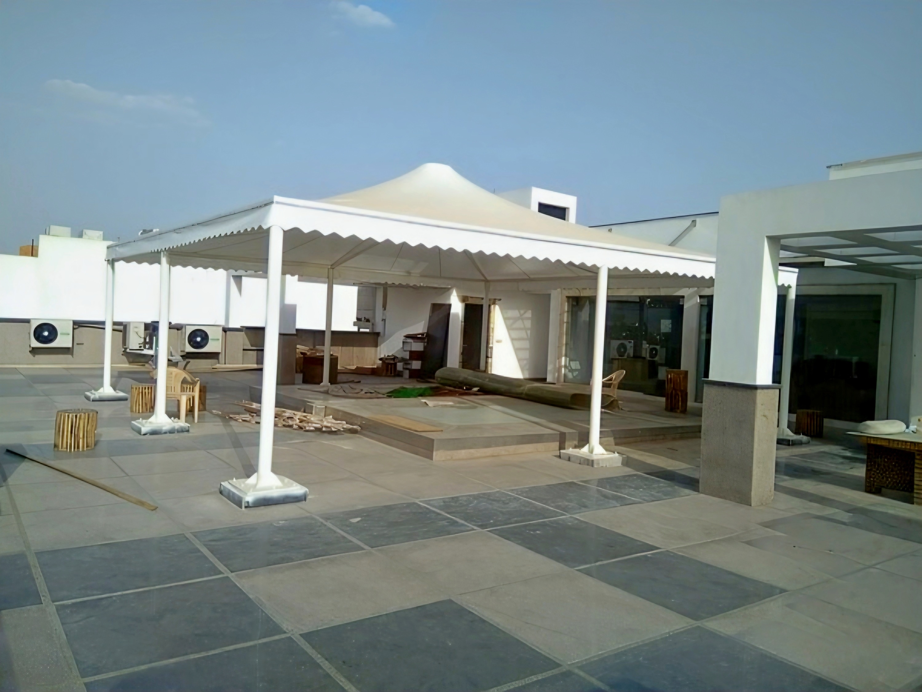 Conical rooftop tensile canopy during installation