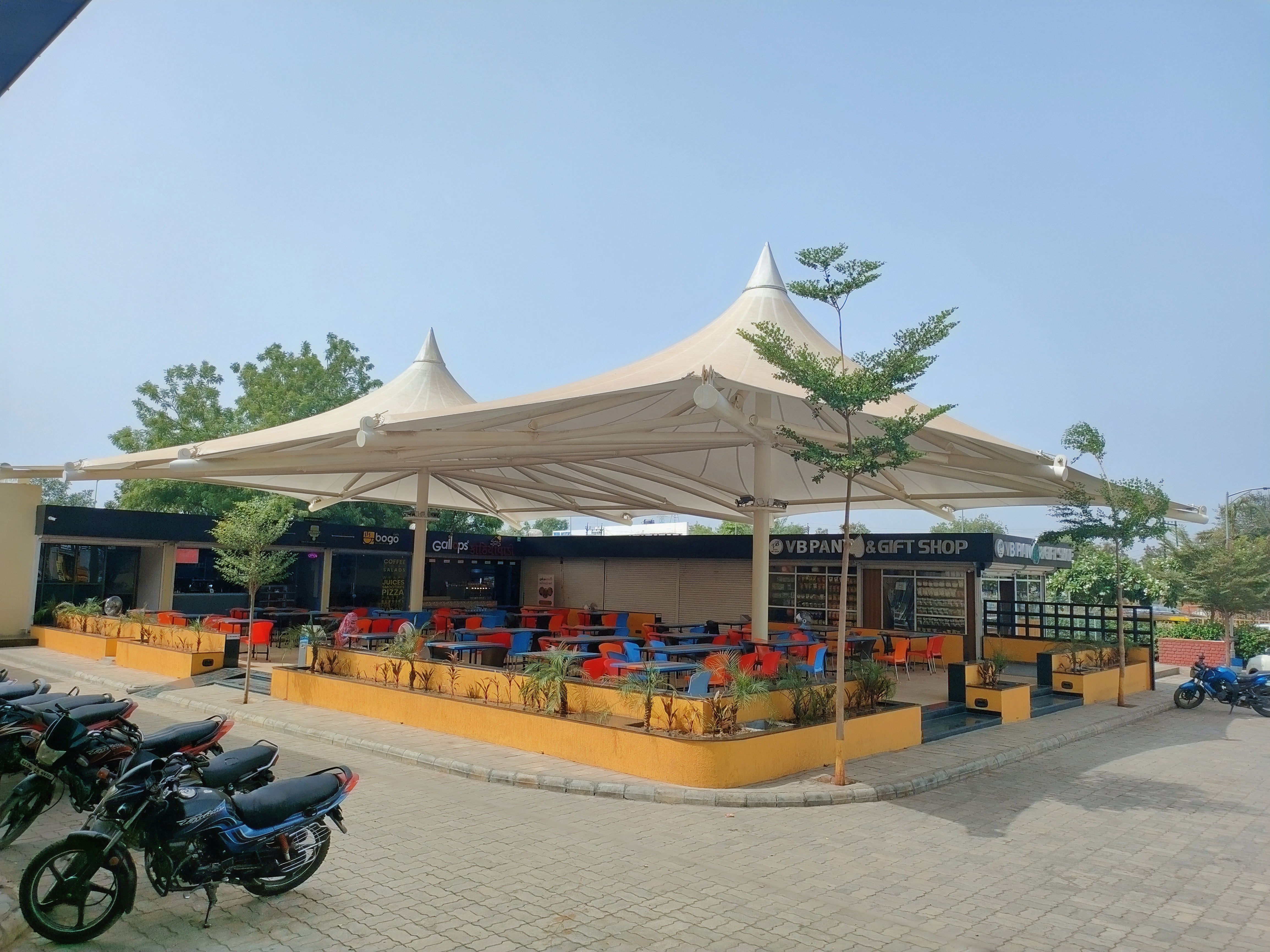 Twin-peak tensile canopy over a retail plaza