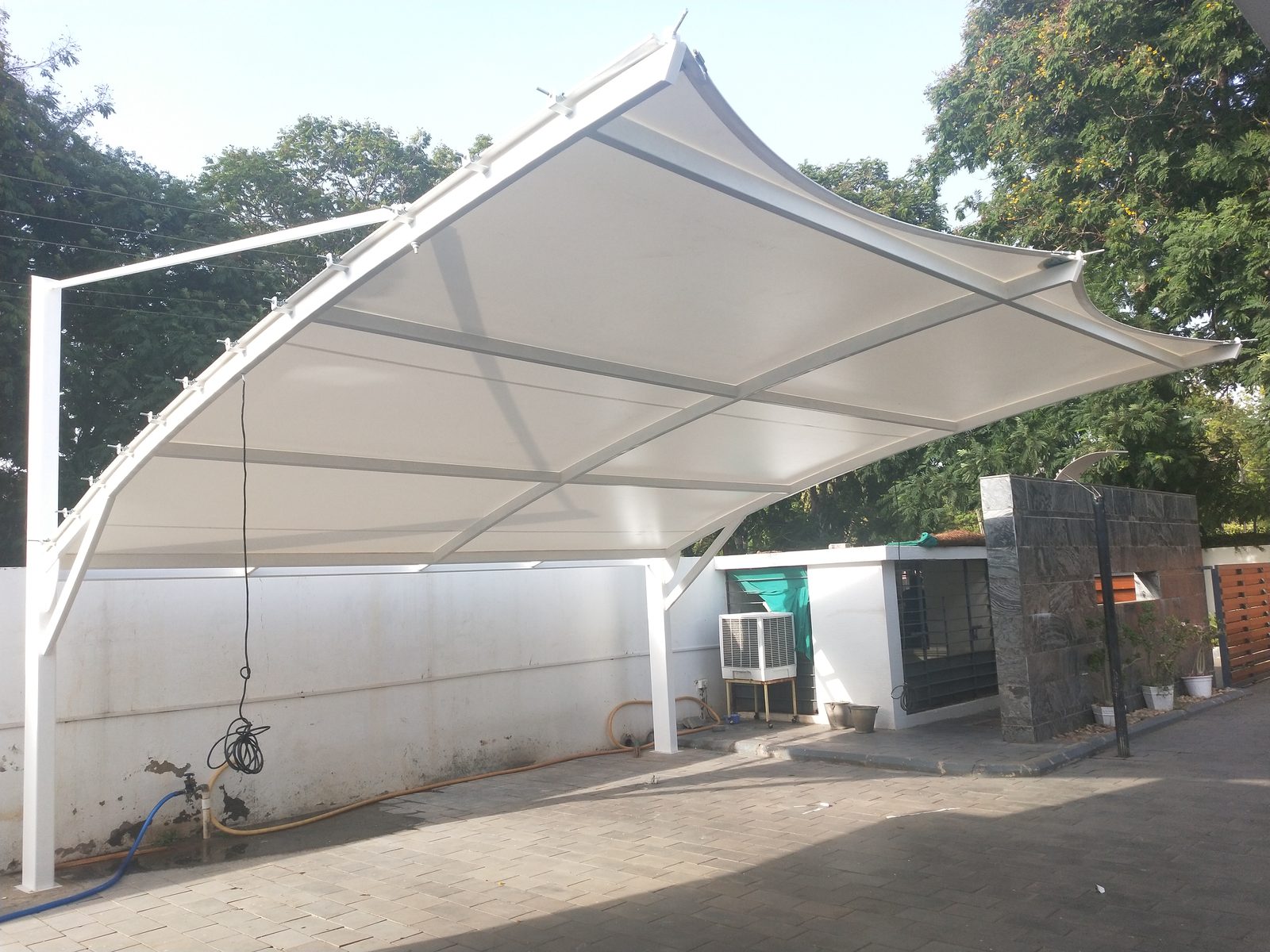 Cross-shaped tensile canopy over a gated entrance